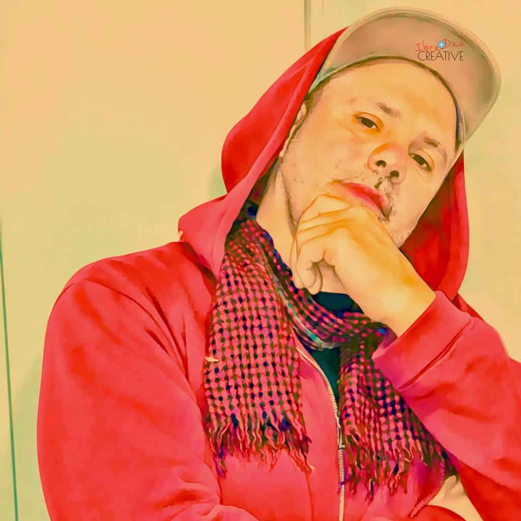 Daniel~Ibrahim in red hoodie - creative entrepreneur and career reinvention coach sharing modern success strategies